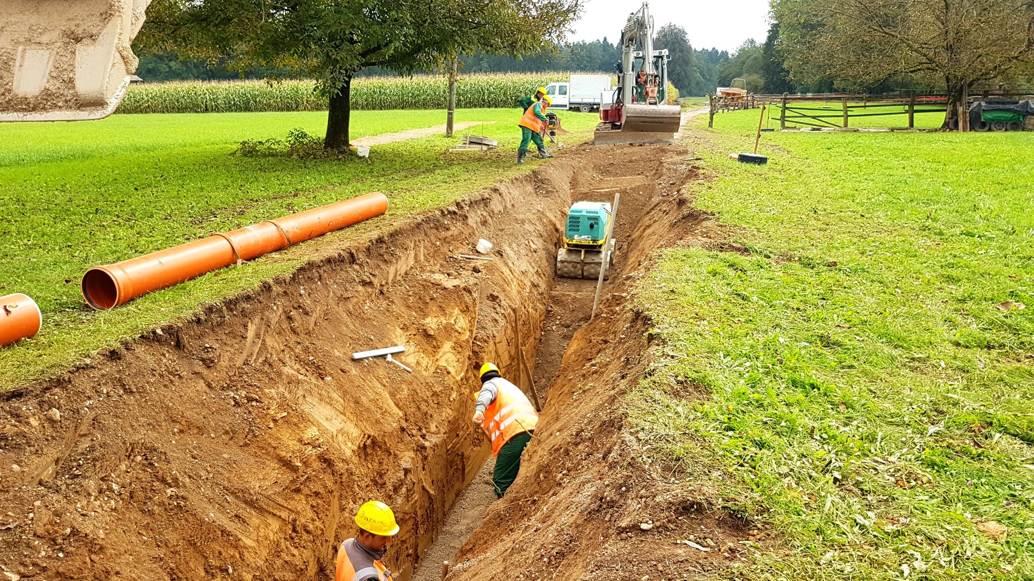 Construction workers digging a trench