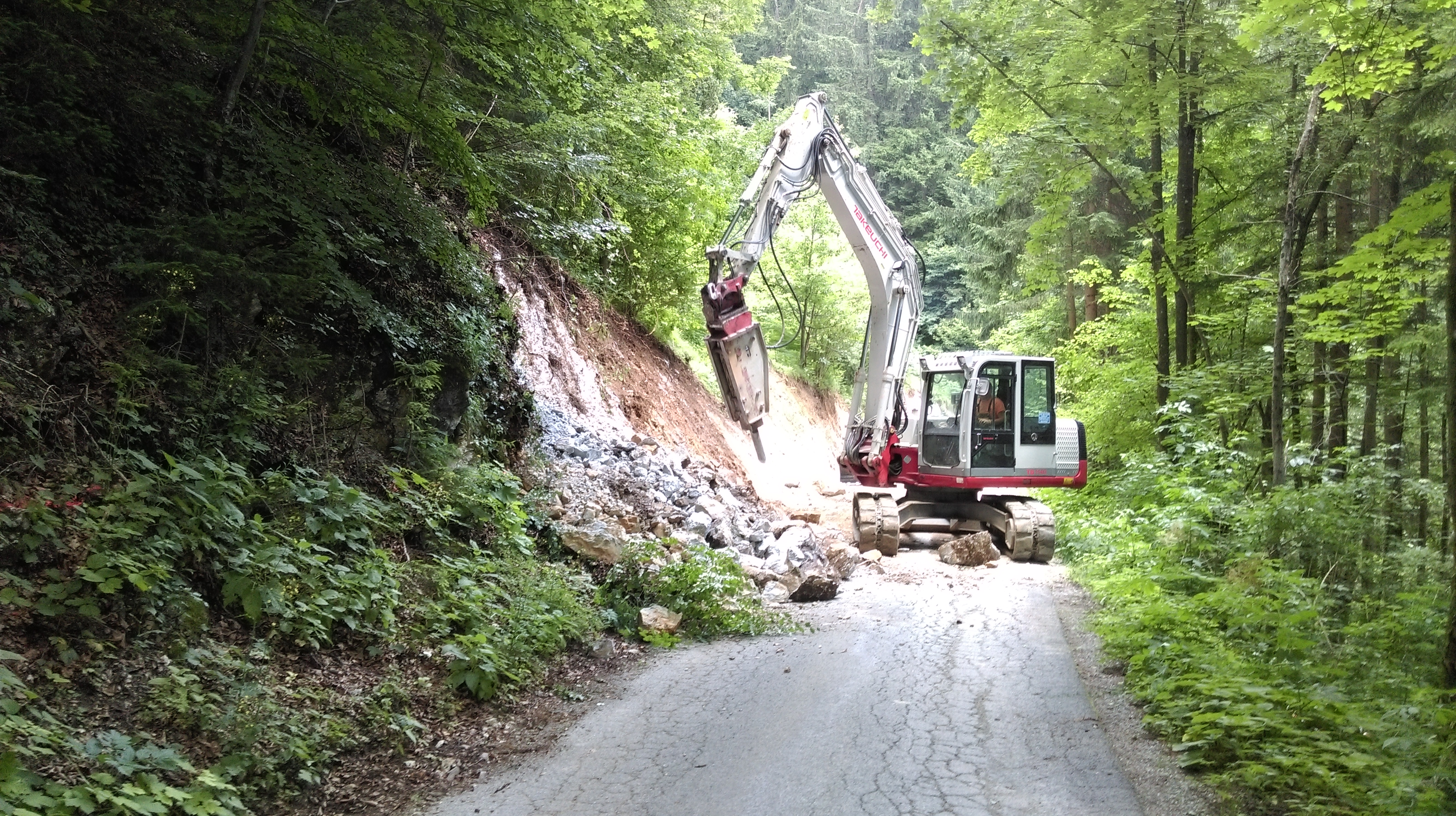 Excavator clearing debris